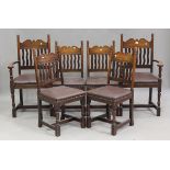 A set of six mid-20th century Arts and Crafts style oak dining chairs with shaped bar and wavy
