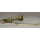 A brass 'Emperor' trombone by Boosey & Hawkes Ltd, with hard case and travel case, together with a