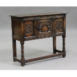 A 20th century Carolean Revival oak side cupboard, fitted with a central carved panel door, height