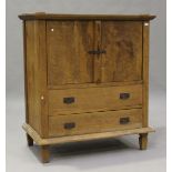 A 20th century hardwood cupboard, fitted with two doors and two drawers, the back with concealed
