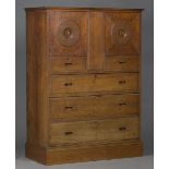 An Edwardian Heal & Sons oak 'Owl' cabinet, designed by Sir Ambrose Heal in 1905-1906, fitted with a