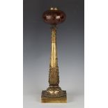 A mid-19th century gilt bronze oil lamp base, the amber glass reservoir with foliate etched