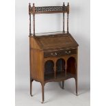 A late Victorian Anglo Moorish mahogany bureau bookcase, possibly by Liberty & Co, the shelf back