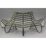 An early 20th century wrought iron tree trunk surround bench of slatted octagonal form, height 74cm,