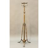 An Edwardian Arts and Crafts brass telescopic oil lamp standard, in the manner of W.A.S. Benson,