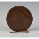 A 19th century oak circular table snuff box, diameter 12.5cm, together with spoon.Buyer’s Premium