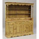 A 20th century pine dresser, the shelf back and base fitted with drawers, height 197cm, width