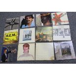 A collection of LP records, including albums by Frank Zappa, REM, Pink Floyd and Genesis, together