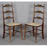 A pair of Edwardian Arts and Crafts beech and mahogany pierced ladder back side chairs, each