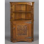 An early 20th century Arts and Crafts walnut corner cabinet, in the manner of Shapland & Petter, the