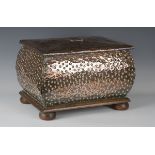 An early 20th century Arts and Crafts copper mounted coal box, the hinged lid worked with foliate