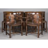 A set of six Arts and Crafts oak framed dining chairs, the design attributed to George Walton and