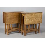 A pair of mid-20th century Arts and Crafts oak drop-flap rectangular occasional tables, probably