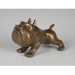 A 20th century patinated cast brass comical model of a bulldog, length 14cm.Buyer’s Premium 29.4% (