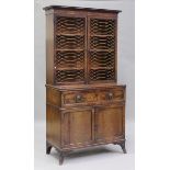 A Regency figured mahogany secrétaire bookcase cabinet, the top with two doors inset with gilt brass