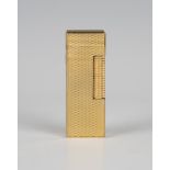 A Dunhill gold plated rectangular gas lighter with engine turned decoration, length 6.3cm,