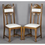 A pair of Edwardian Arts and Crafts oak framed side chairs, in the manner of Shapland & Petter,