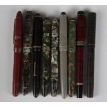 A collection of various fountain pens and parts, including Watermans, Conway Stewart, Osmiroid and a