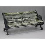 A late Victorian black painted cast iron garden bench with wooden slatted seat and back, the