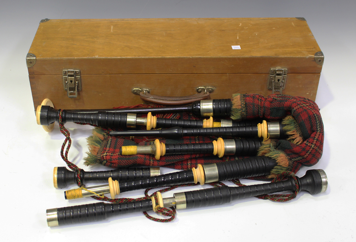 A set of early 20th century Scottish bagpipes with nickel and ivory mounts, the rosewood chanter