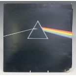 An LP record by Pink Floyd, 'Dark Side of the Moon', first pressing with solid blue prism label,