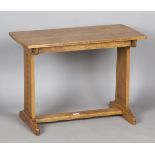 A mid-20th century Arts and Crafts style oak rectangular occasional table, in the manner of