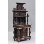 A late 19th/early 20th century Continental carved oak side cabinet with a panelled shelf back
