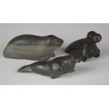 A group of three Canadian Inuit carved green stone models of seals, one incised 'Mathewsie E-91546',