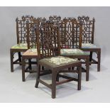 A set of six George III Chinese Chippendale style mahogany dining chairs with carved foliate top