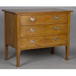 An Edwardian Arts and Crafts oak chest of drawers, in the manner of Liberty & Co, the three