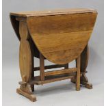 A 20th century Arts and Crafts style oak oval gateleg table, raised on shaped supports, height 76cm,