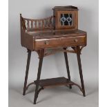 An Edwardian Arts and Crafts mahogany writing table, in the manner of Liberty & Co, the gallery back