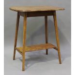 An Edwardian Arts and Crafts oak curved rectangular lamp table, raised on square tapering legs,