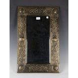 An early 20th century Arts and Crafts brass rectangular wall mirror, probably Scottish and in the