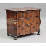 An 18th century Dutch floral marquetry serpentine fronted bombé commode, fitted with three