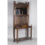 An Edwardian Arts and Crafts stained oak hall stand, in the manner of Shapland & Petter, inset