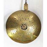 An 18th century brass and steel handled warming pan, length 108cm (faults).Buyer’s Premium 29.4% (