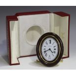 A Cartier gilt brass and brown lacquer bedside alarm clock, Ref. 7509, with manual wind movement,