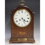 An Edwardian mahogany mantel clock with eight day movement striking on a gong, the white enamel