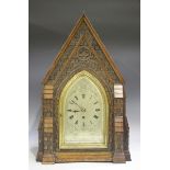 A late Victorian carved oak bracket clock of architectural church form, with eight day triple