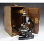 A mid-20th century black enamelled monocular microscope, signed 'J. Swift & Son London' and numbered