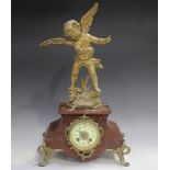 A late 19th/early 20th century French gilt metal and rouge marble mantel clock with eight day
