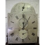 A George III oak longcase clock with eight day movement striking hours on a bell, the silvered