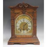 A late 19th century German walnut cased mantel clock with eight day movement striking on two