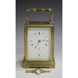 A late 19th century French engraved brass one-piece cased carriage alarm clock with eight day