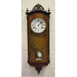 A late 19th century walnut and ebonized Vienna style wall clock with eight day movement striking