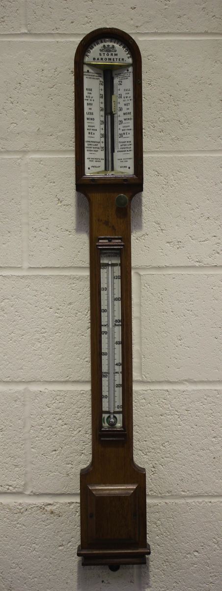 A late Victorian pale oak Admiral Fitzroy's storm stick barometer, the ceramic dial with vernier
