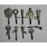 A group of ten watch keys, the terminals including a pistol and a copy of an Ancient Greek coin.