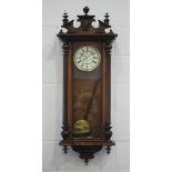 A late 19th century walnut Vienna style wall clock with eight day movement striking on a gong, the