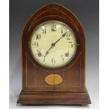 An Edwardian mahogany mantel clock with eight day movement striking on a gong, the circular dial